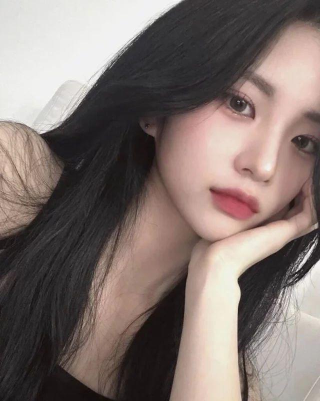 Professional portrait of Jiyoung in soft lighting, wearing neutral-toned attire