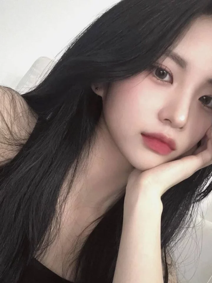 Professional portrait of Jiyoung in soft lighting, wearing neutral-toned attire